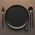 Mealtime elegance Top view of black plate with utensils