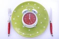 Mealtime table place setting with alarm clock Royalty Free Stock Photo