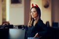 Mean Boss Wearing Devil Horns in the Office with Condescending Attitude