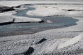 Meandering river flowing during low tide, waste landscape