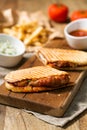 Meaning style chicken panini on wooden cutting board in the kitchen Royalty Free Stock Photo