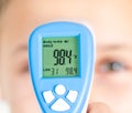 Measure of body temperature by infrared thermometer Royalty Free Stock Photo