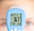 Measure of body temperature by infrared thermometer Royalty Free Stock Photo