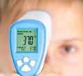 Measure of body temperature by infrared thermometer Royalty Free Stock Photo