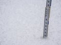 Measure the snow depth with a folding rule Royalty Free Stock Photo