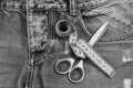 Measure tape around metal scissors on jeans fabric Royalty Free Stock Photo