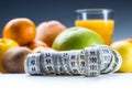 Measure tape and fresh fruit in the background Royalty Free Stock Photo