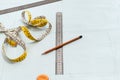 Measure tape, rulers and pencil on pattern layout