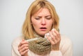 Measure temperature. Woman feels badly ill sneezing. Girl in scarf hold thermometer and tissue close up. Cold and flu Royalty Free Stock Photo