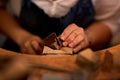 Measure twice cut once. An artist creating something out of wood.