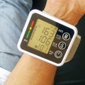 Measure your blood pressure at home using a portable device to check Your health. The device shows a high pressure value Royalty Free Stock Photo