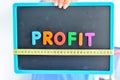 Measure your profit concept written as magnetic colored letter blocks with measuring tape Royalty Free Stock Photo