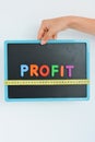 Measure your profit concept written as magnetic colored letter blocks with scale