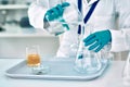 Measurement is key...an unrecognizable female scientist transferring a liquid from a beaker to a conical flask while Royalty Free Stock Photo