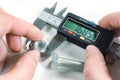 Measurements by a digital caliper in the master`s hand Royalty Free Stock Photo