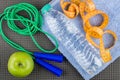 Measures tape and bottle of water on towel, jump rope