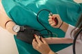 Measuring blood pressure with a sphygmomanometer. Close-up shot