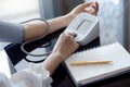 measuring blood pressure by using digital sphygmomanometer Royalty Free Stock Photo