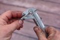 Measuring with vernier caliper bolt diameter for locksmithing work.