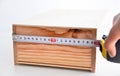 Measuring a box with roulette Royalty Free Stock Photo