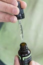 Measuring the correct amount of cbd oil from a brown tincture bottle