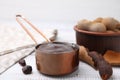 Measuring cup with tasty tamarind sauce and fresh pods on white wooden table