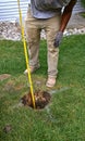 Digging and measuring depth for a pole hole for a new fence