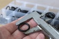 Measuring the diameter of the rubber O-ring with a caliper. Royalty Free Stock Photo