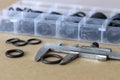 Measuring the diameter of the rubber O-ring with a caliper. Royalty Free Stock Photo