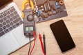 Measuring the electronic components on the motherboard of the computer and smartphone. Royalty Free Stock Photo