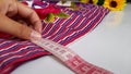 measuring fabric for sewing using a fabric meter on a white background Royalty Free Stock Photo