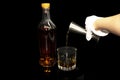 Measuring glass in bar pub nightlife, Waitress serving whiskey alchol golden drink