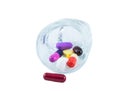 Measuring glass with capsules and tablets Royalty Free Stock Photo
