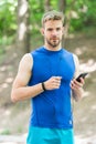 Measuring heart rate. sport app on phone. digital sport. smart watch. athletic man in sportswear. outdoor workout Royalty Free Stock Photo