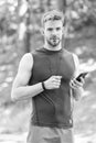 Measuring heart rate. sport app on phone. digital sport. smart watch. athletic man in sportswear. outdoor workout Royalty Free Stock Photo