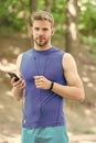 Measuring heart rate. sport app on phone. digital sport. smart watch. athletic man in sportswear. outdoor workout Royalty Free Stock Photo