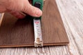 Measuring the length of the board with a tape measure Royalty Free Stock Photo