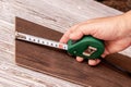 Measuring the length of the board with a tape measure Royalty Free Stock Photo