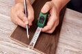 Measuring and marking the board with a tape measure Royalty Free Stock Photo