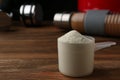 Measuring scoop of protein powder on  table, closeup. Space for text Royalty Free Stock Photo