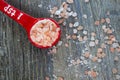 Measuring spoon fulll of Pink Himalayan Salt on Rustic Wood Back Royalty Free Stock Photo