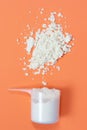 Measuring spoon with scattered protein powder on a orange background Royalty Free Stock Photo