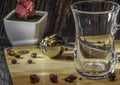 Measuring spoon for tea and coffee with coffee beans and dry tea leaves on a wooden plate