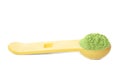 Measuring spoon with wheat grass powder on white Royalty Free Stock Photo