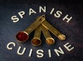 Measuring spoons filled with various spices used in Spanish cooking. Royalty Free Stock Photo