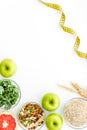 Measuring tape, apples, oat meal and grapefruit for loosing weight on white background top view mockup Royalty Free Stock Photo