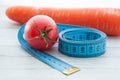 Measuring tape, juicy tomato and carrot, the concept of healthy eating and losing weight Royalty Free Stock Photo