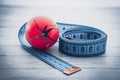 Measuring tape and juicy tomato, the concept of healthy nutrition and weight loss Royalty Free Stock Photo