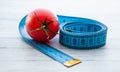 Measuring tape and juicy tomato, the concept of healthy nutrition and weight loss Royalty Free Stock Photo