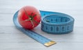 Measuring tape and juicy tomato, the concept of healthy nutrition and weight loss Royalty Free Stock Photo